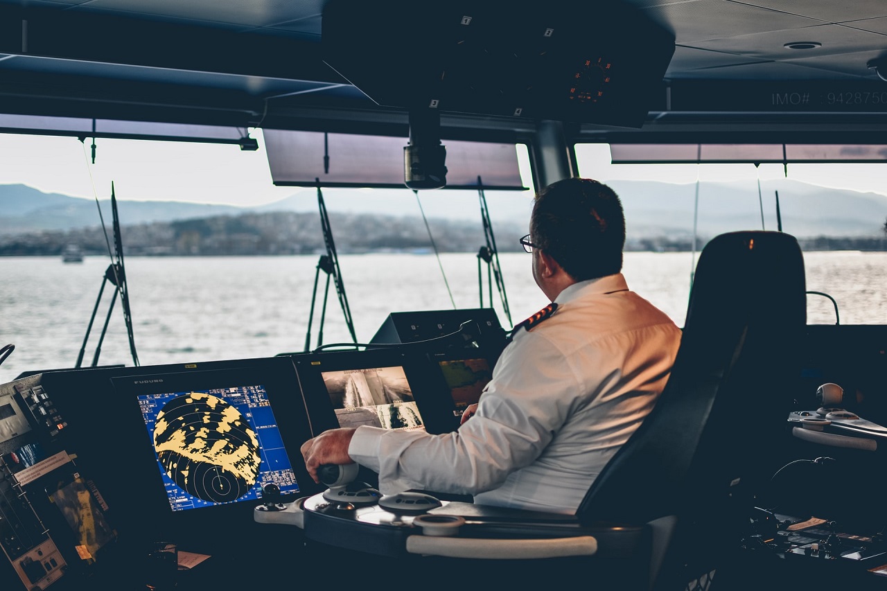 captain in cockpit controlling cruise ferry