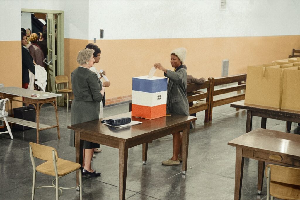 women casting vote in polling station