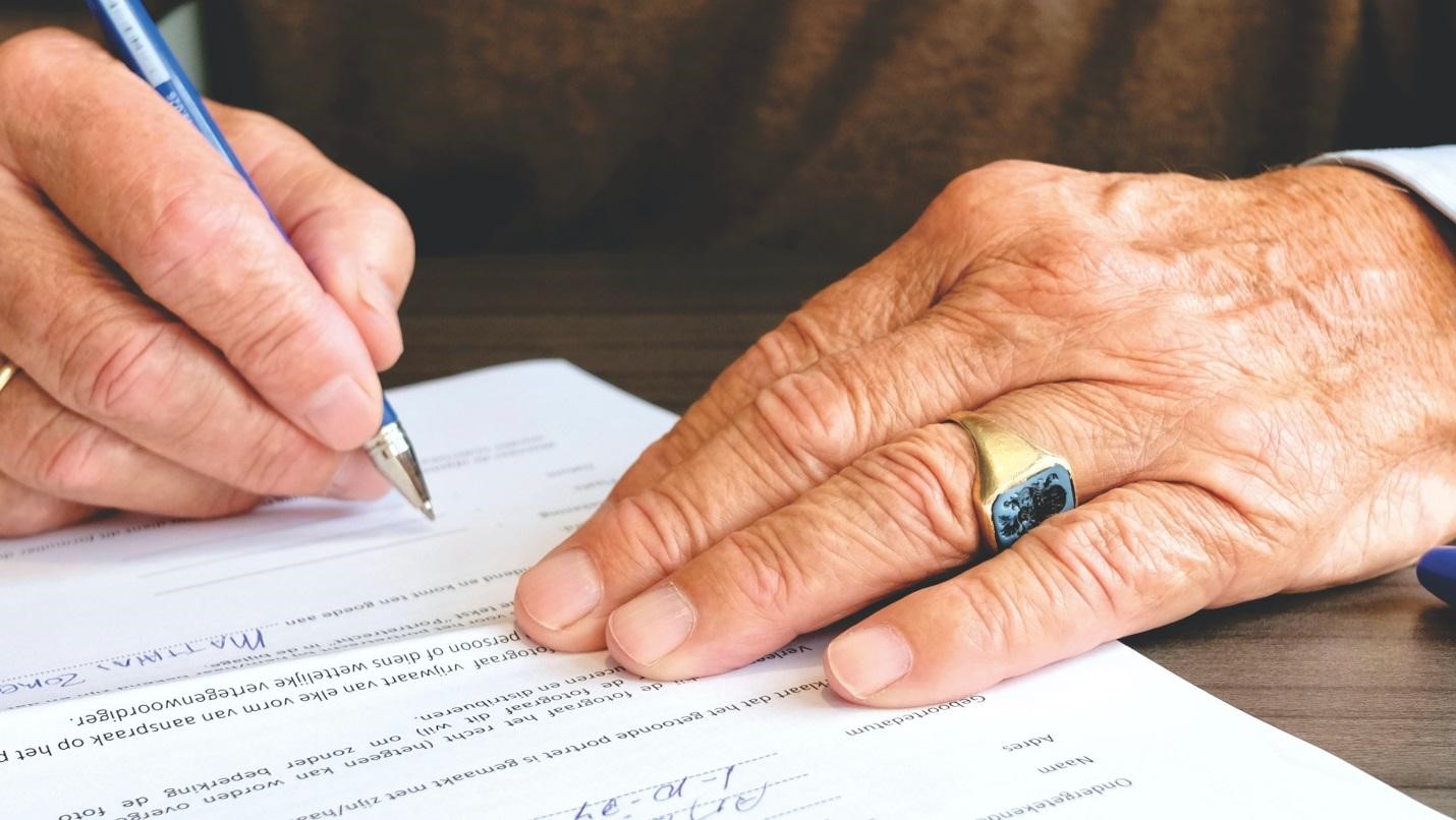 person signing a document